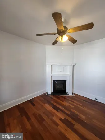 a view of empty room with fan and fan
