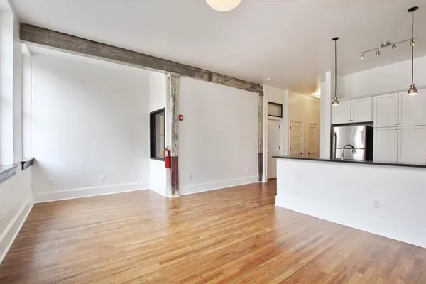 a view of a kitchen with wooden floor and a sink