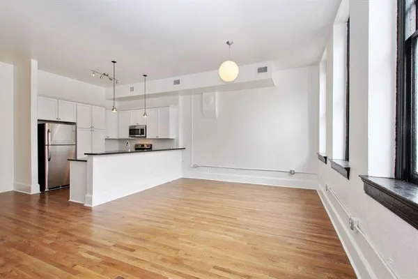a view of kitchen with refrigerator microwave and stove