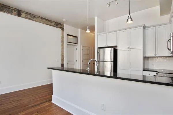 a kitchen with stainless steel appliances granite countertop a refrigerator sink and cabinets