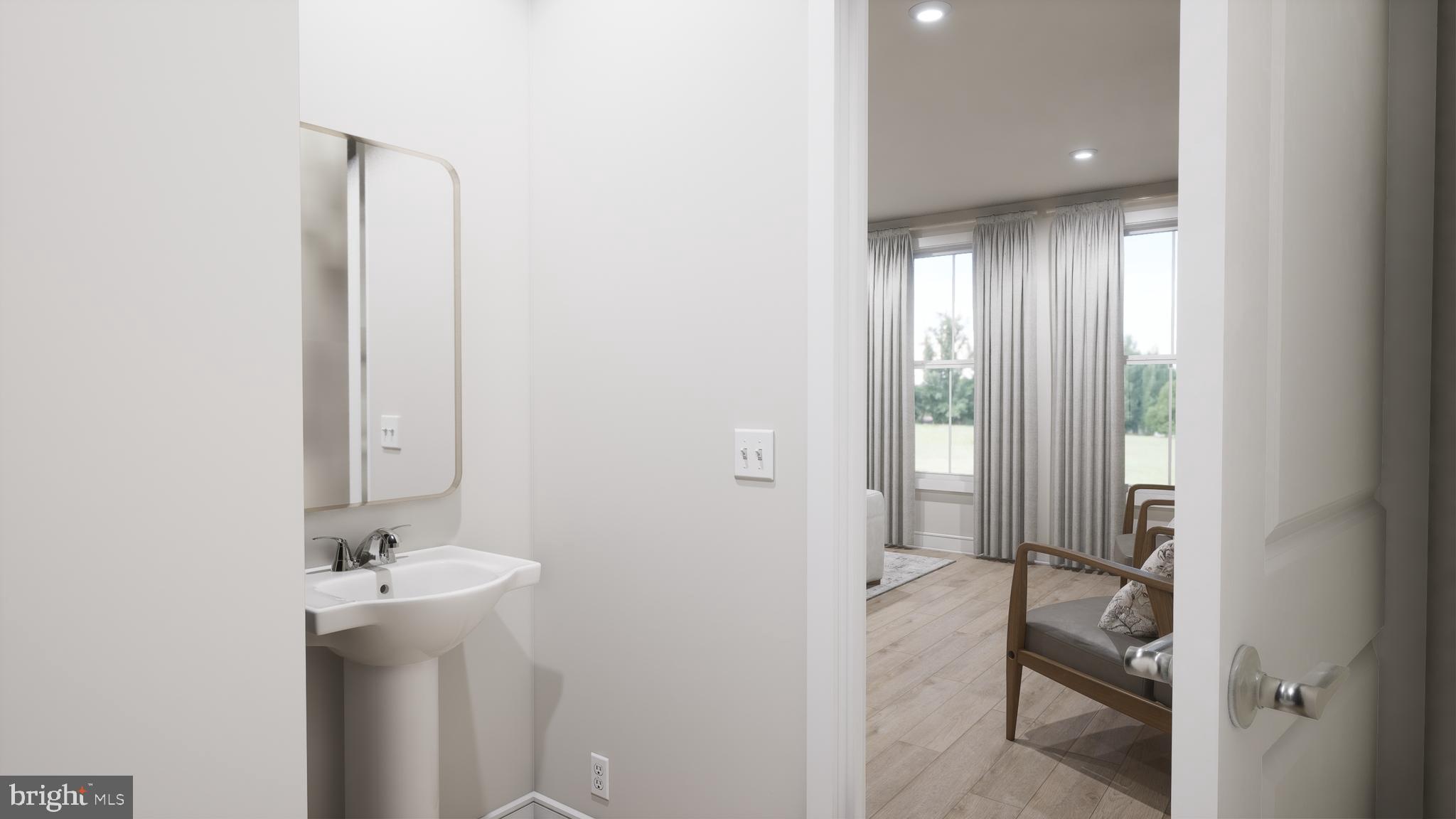 44476 Lowestoft Square Ashburn, VA 20147 - Photo 19 of 27 a bathroom with a sink and mirror with toilet