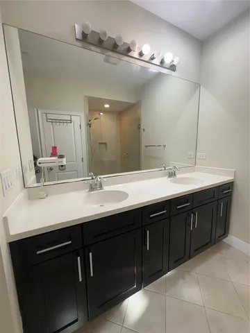 a bathroom with a double vanity sink a and mirror