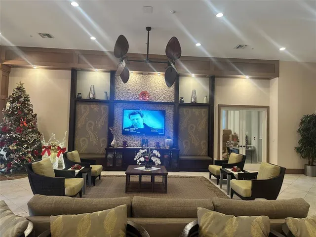 a living room with lots of furniture and kitchen view