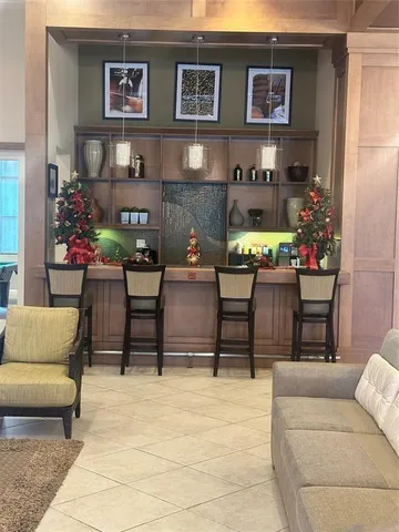 a room with pool table and windows