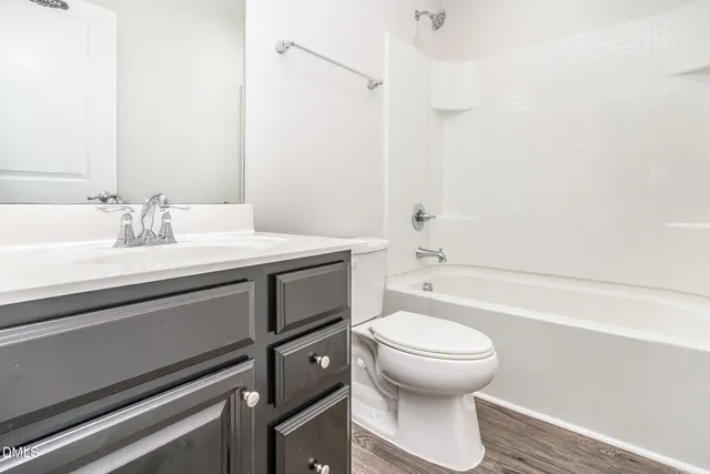 a bathroom with a sink a toilet and a bathtub