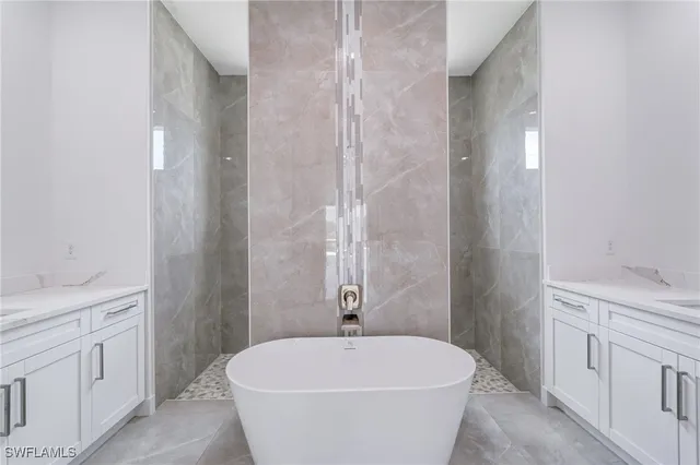 a spacious bedroom with a large bed and a potted plant