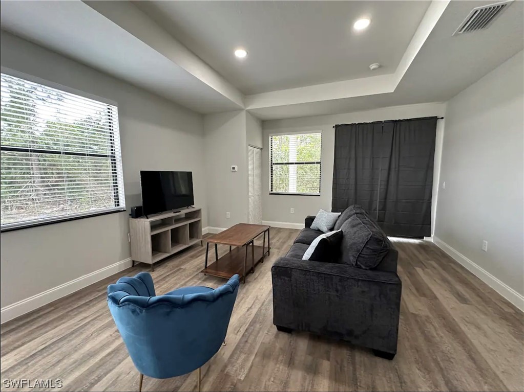 3027 North Lakewood Road LaBelle, FL 33935 - Photo 3 of 5 a living room with furniture a flat screen tv and a window