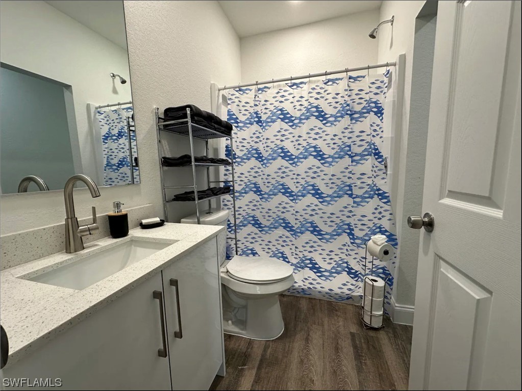 3027 North Lakewood Road LaBelle, FL 33935 - Photo 4 of 5 a bathroom with a sink toilet and shower