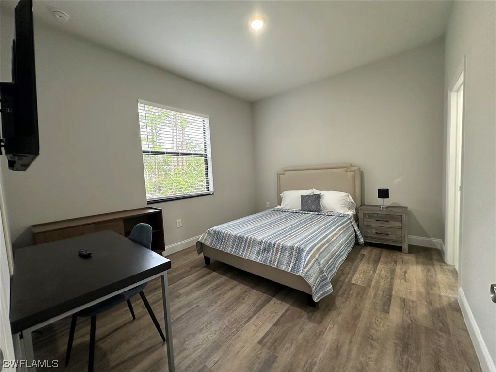 3027 North Lakewood Road LaBelle, FL 33935 - Photo 5 of 5 a bedroom with a bed a desk and chair
