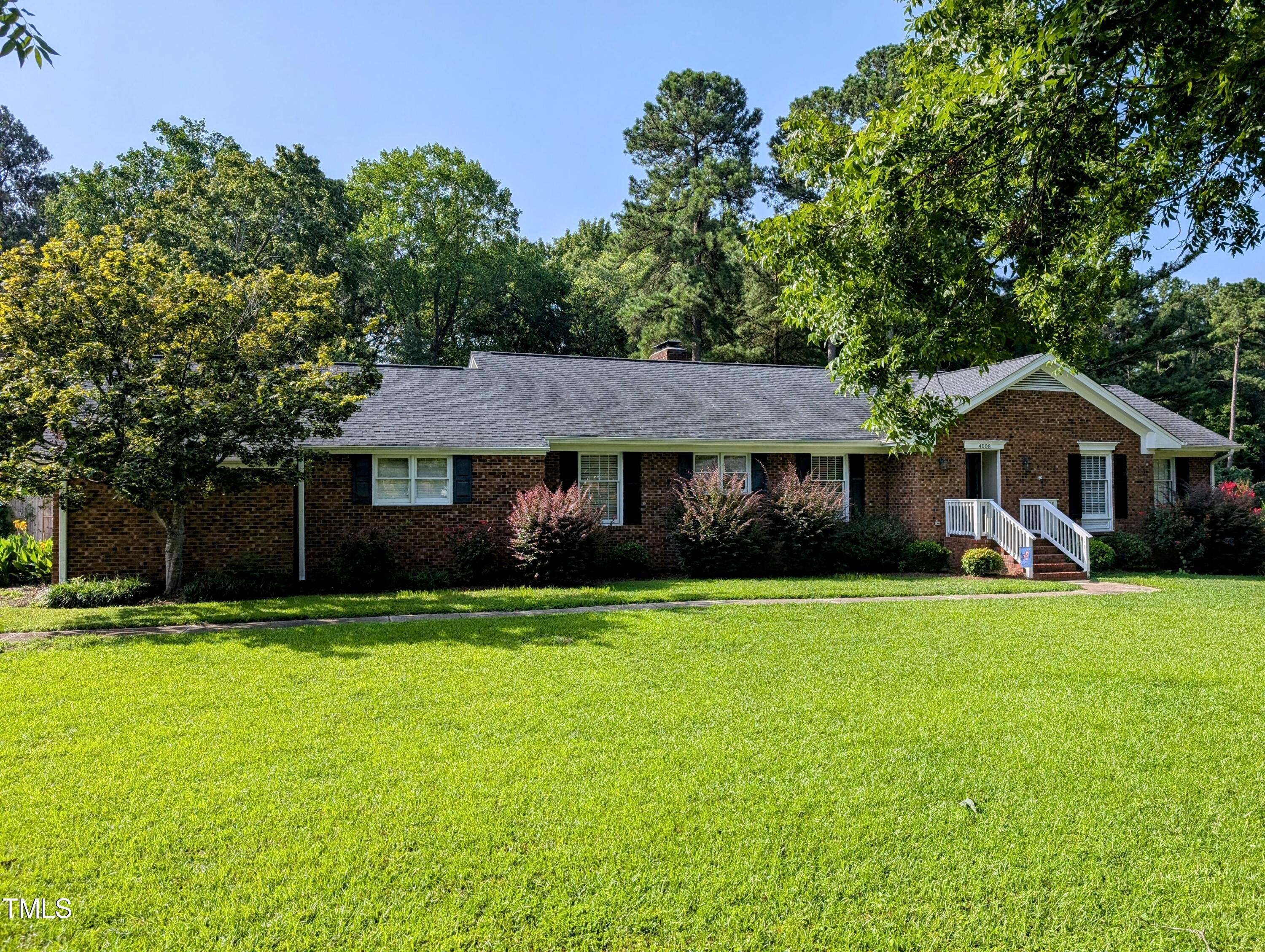4008 Brown Place Raleigh, NC 27604 - Photo 1 of 14 a front view of a house with a yard