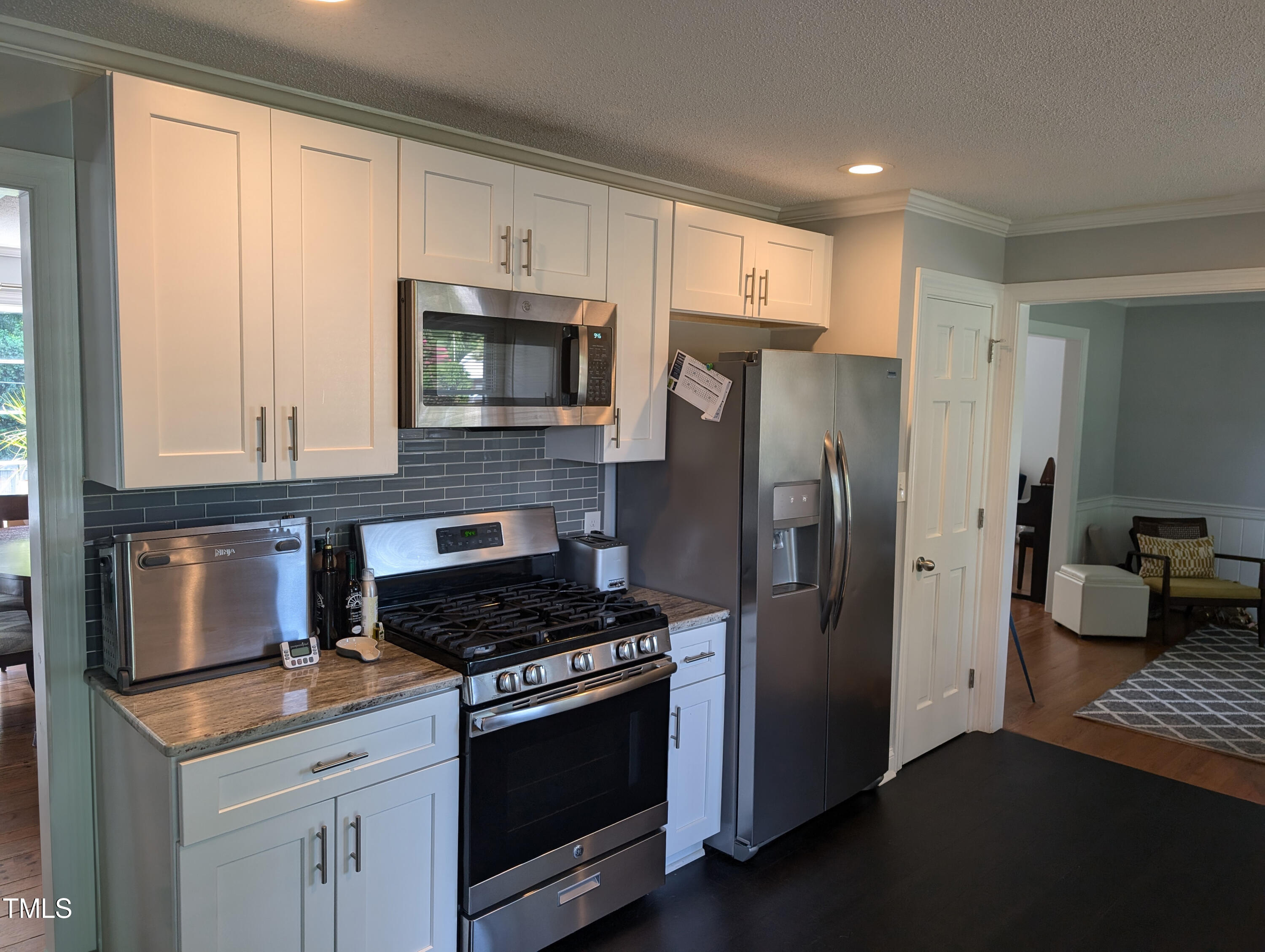 4008 Brown Place Raleigh, NC 27604 - Photo 3 of 14 a kitchen with stainless steel appliances a stove microwave and refrigerator