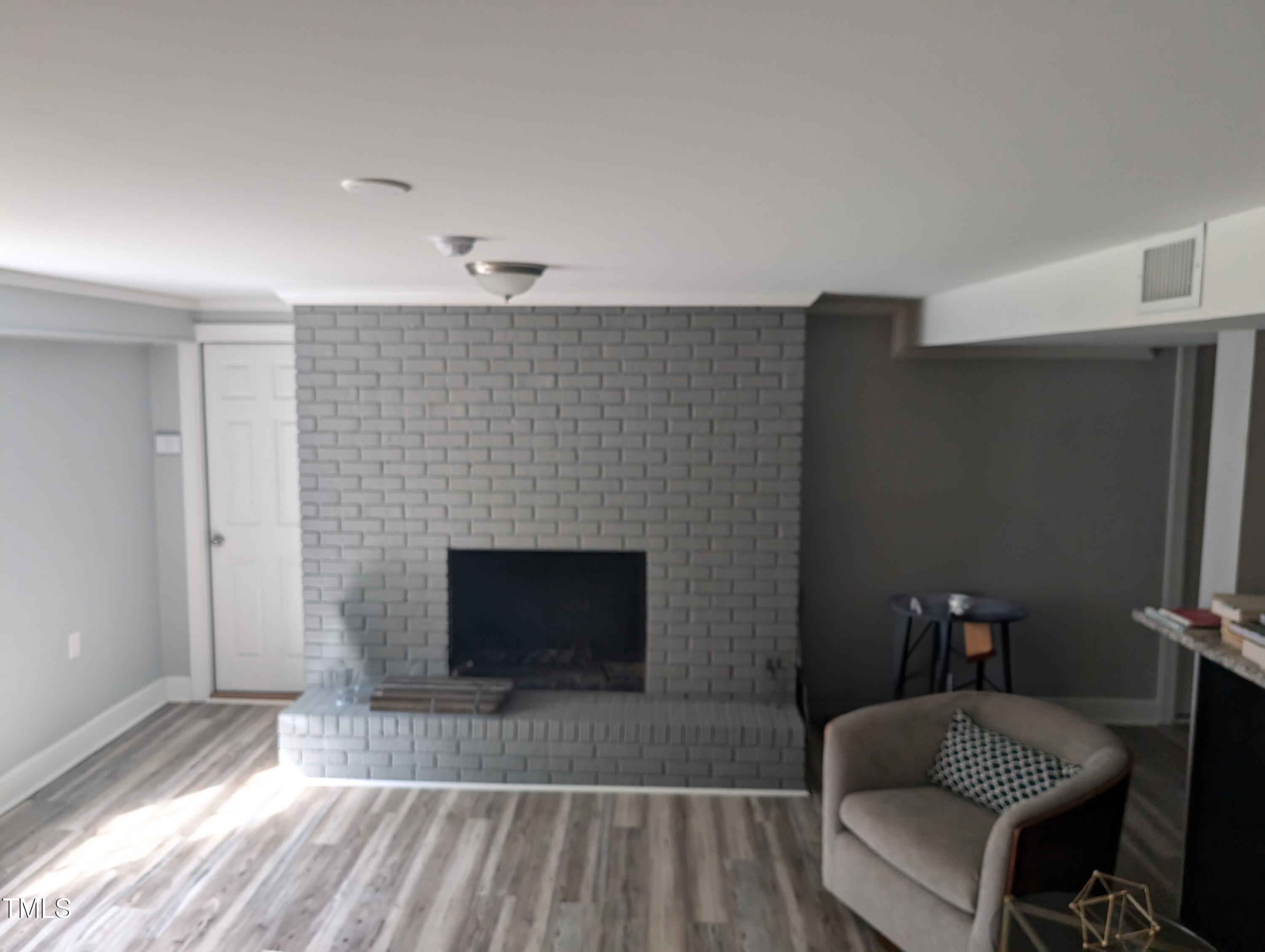 4008 Brown Place Raleigh, NC 27604 - Photo 10 of 14 a living room with furniture a flat screen tv and a fireplace