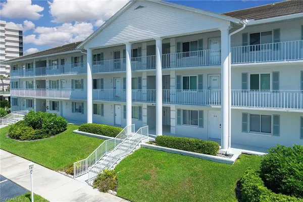 a view of a brick building next to a yard