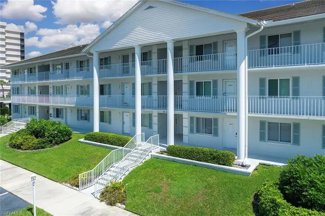 a view of a brick building next to a yard