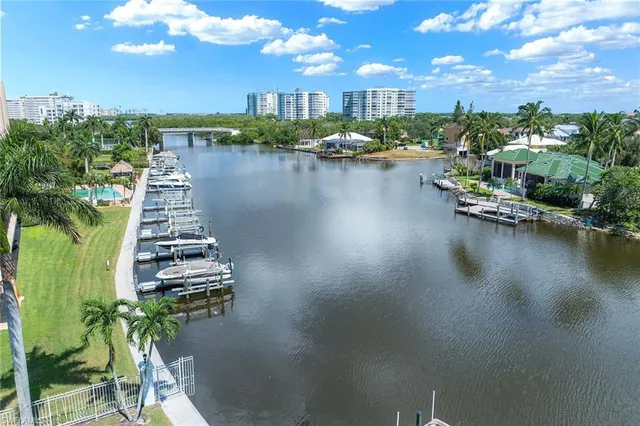 a view of a swimming pool with lawn chairs under an umbrella