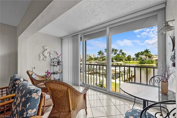 a living room with furniture a flat screen tv and a table