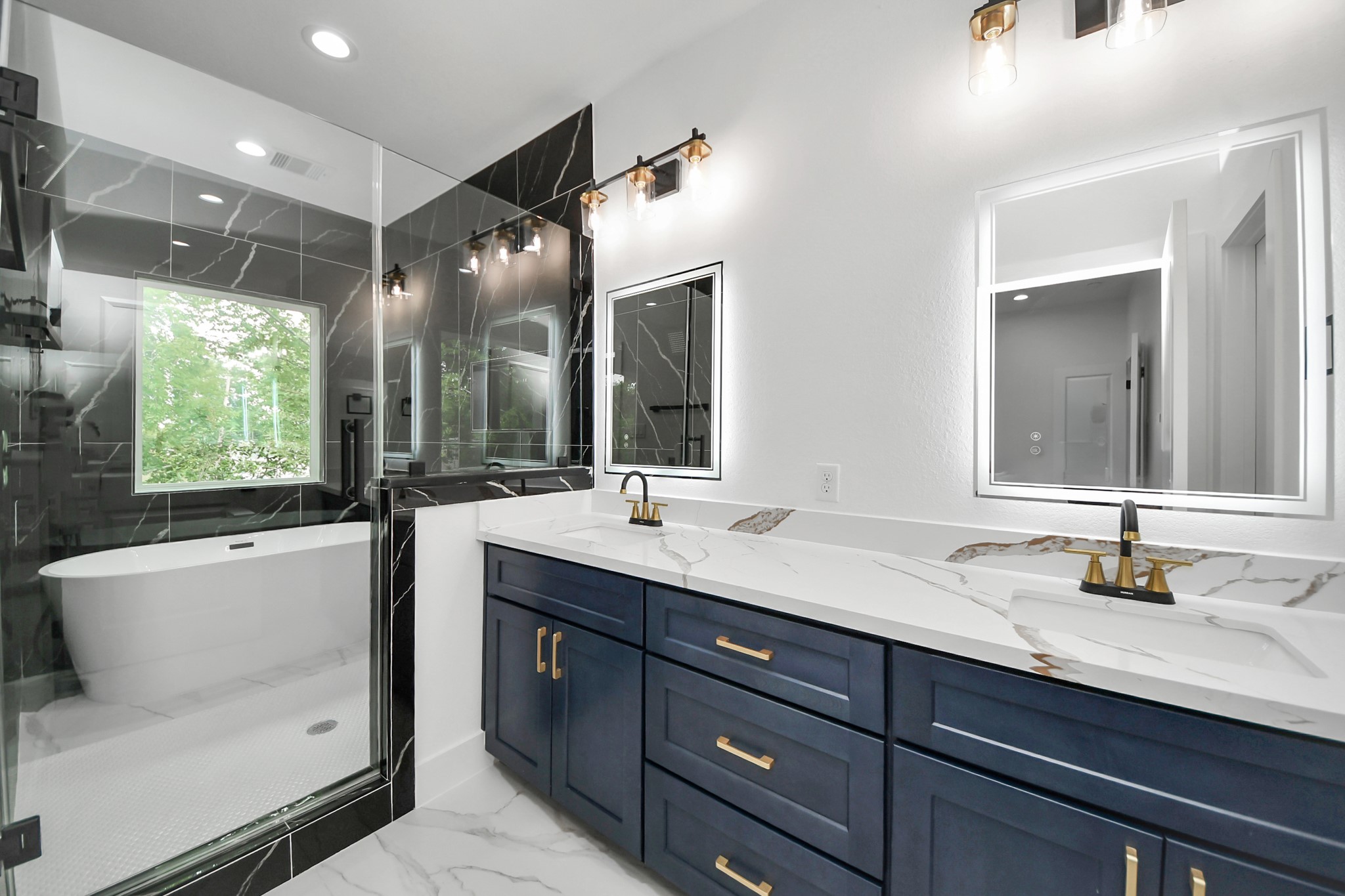 6629 Foster Street Houston, TX 77021 - Photo 5 of 33 Luxurious primary bathroom featuring dual vanities and designer tile work.