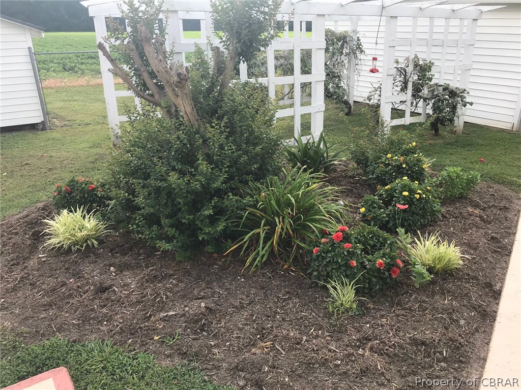 515 Stormont Road Saluda, VA 23149 - Photo 23 of 25 Just one of the gardens the owner has established, notice two detached sheds for storage.