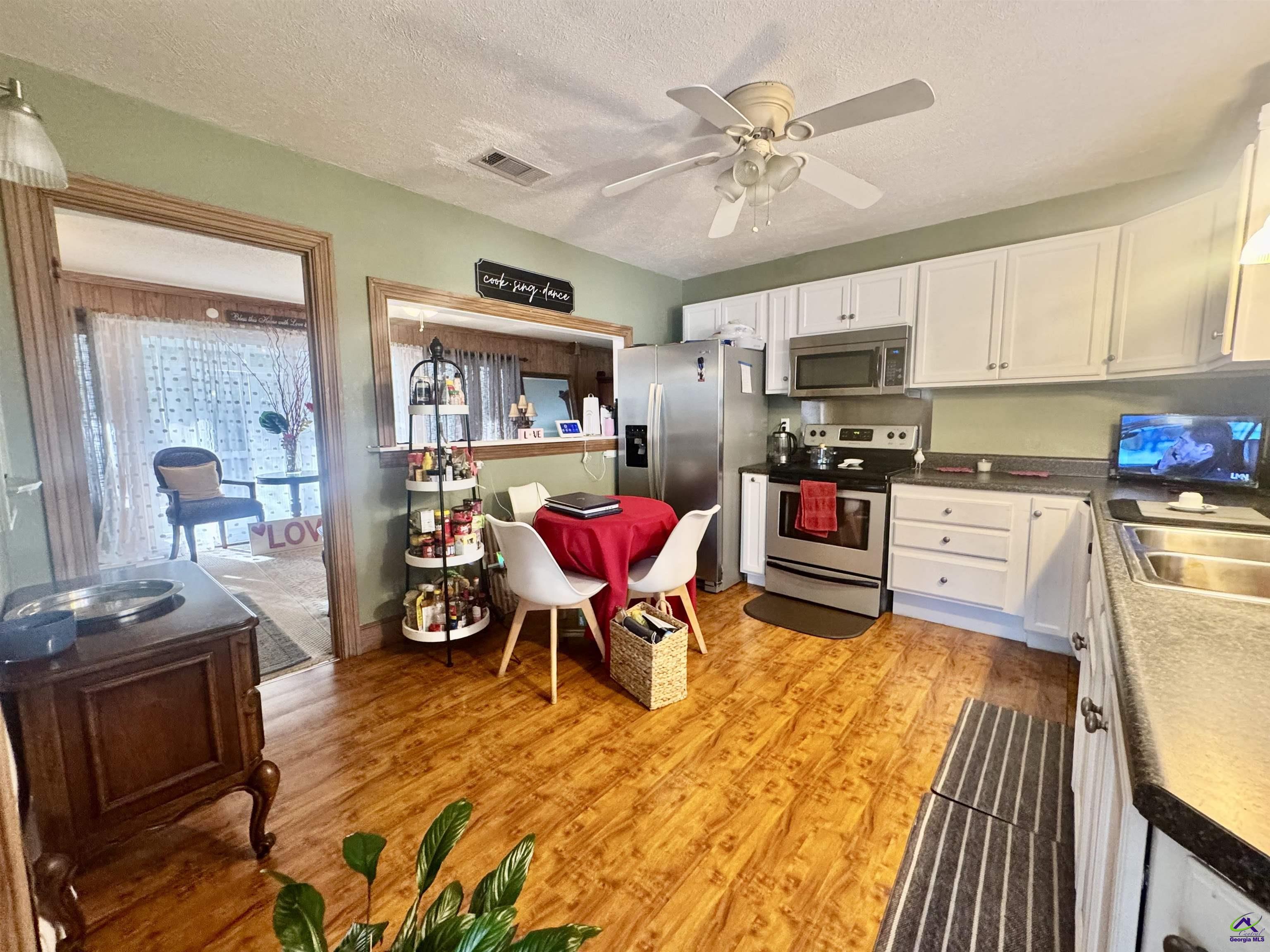914 Adderton Street Americus, GA 31719 - Photo 34 of 53 a living room with stainless steel appliances kitchen island granite countertop furniture and a kitchen view