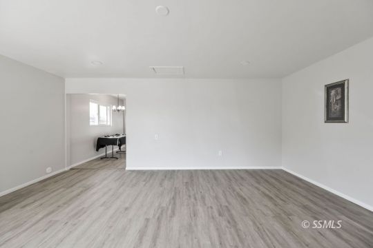 420 West Upjohn Avenue Ridgecrest, CA 93555 - Photo 20 of 32 an empty room with wooden floor and windows