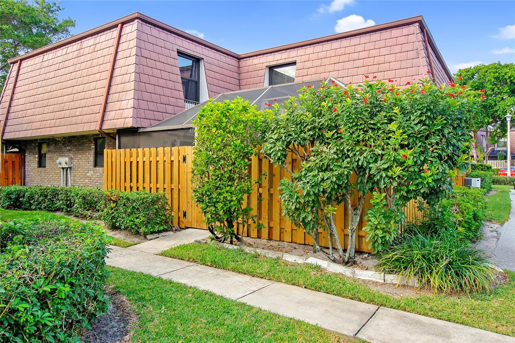 a view of a house with a small yard and plants