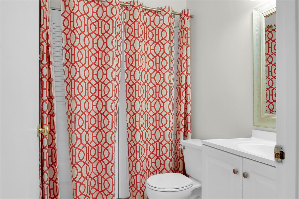 7801 Courtyard Run West Boca Raton, FL 33433 - Photo 13 of 31 a white toilet sitting next to a shower curtain