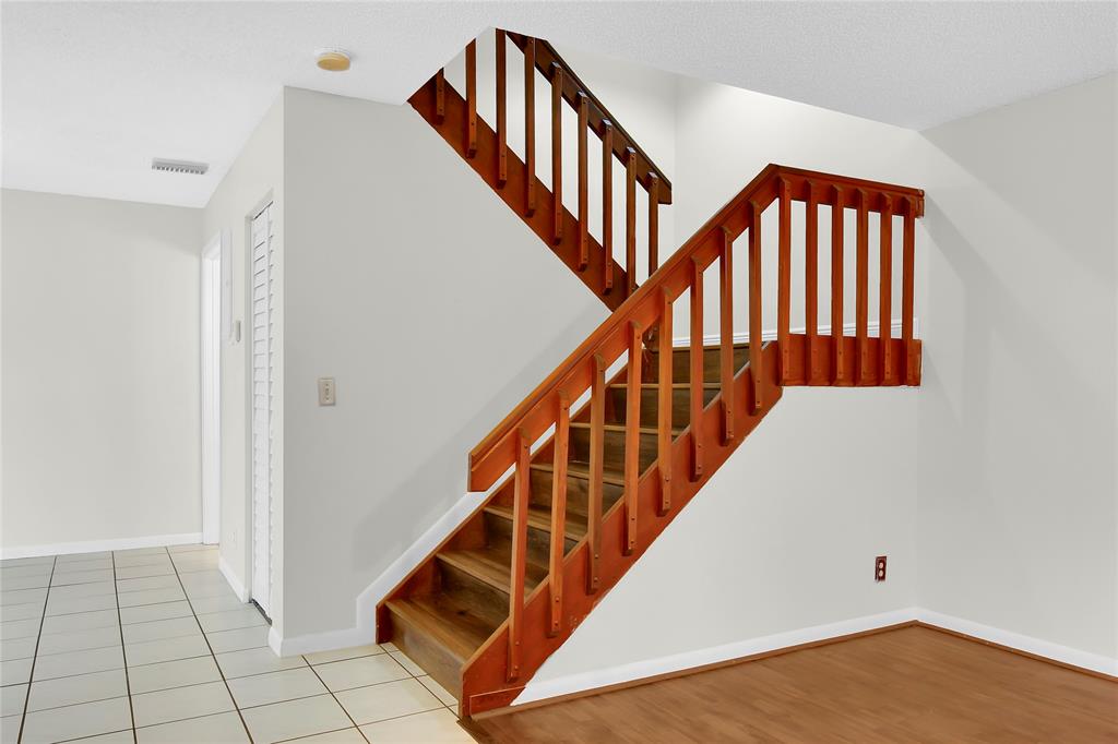 7801 Courtyard Run West Boca Raton, FL 33433 - Photo 14 of 31 a view of staircase with white walls and a window