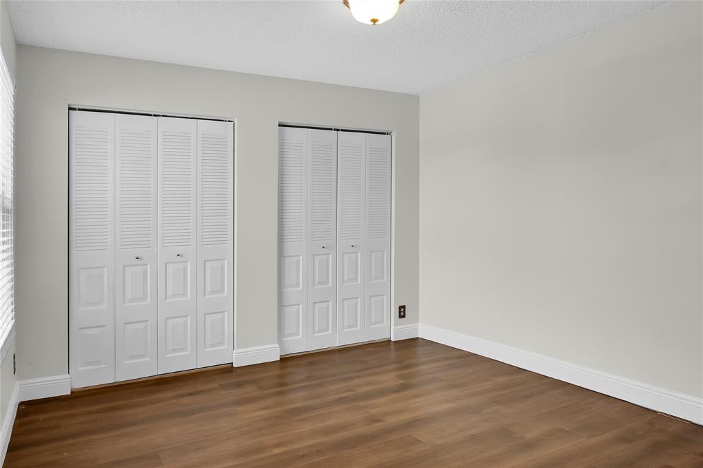 7801 Courtyard Run West Boca Raton, FL 33433 - Photo 21 of 31 a view of an empty room with wooden floor