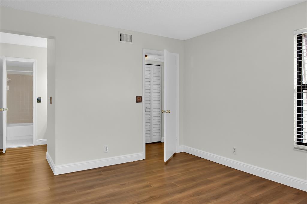 7801 Courtyard Run West Boca Raton, FL 33433 - Photo 24 of 31 a view of an empty room with wooden floor and a window