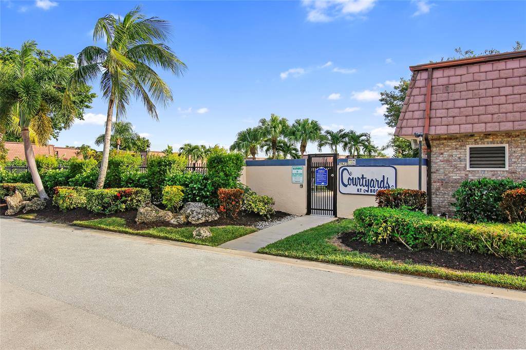 7801 Courtyard Run West Boca Raton, FL 33433 - Photo 27 of 31 a front view of a house with a yard and a garage