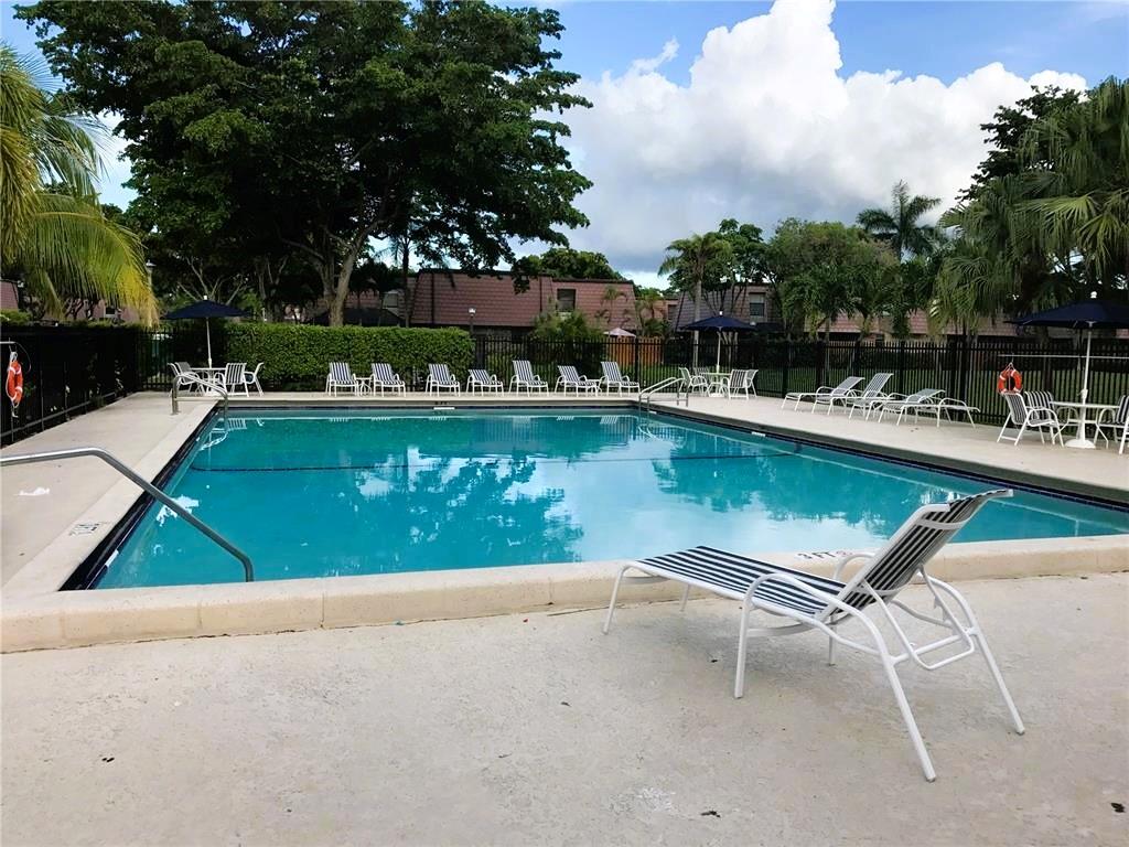 7801 Courtyard Run West Boca Raton, FL 33433 - Photo 31 of 31 a view of a swimming pool with a table and chairs