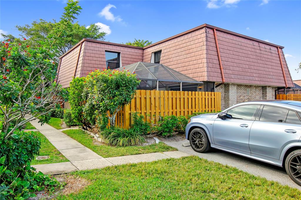 7801 Courtyard Run West Boca Raton, FL 33433 - Photo 4 of 31 a front view of a house with a garden