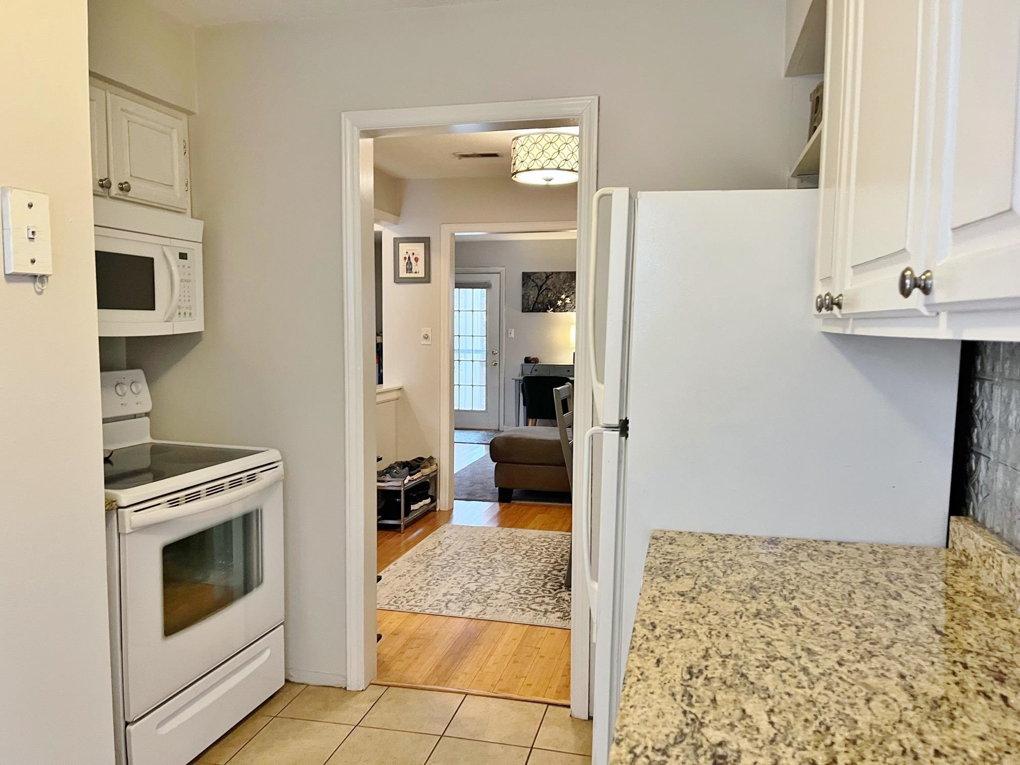 6313 New Market Way, Unit 6313 Raleigh, NC 27615 - Photo 11 of 18 a kitchen with stainless steel appliances granite countertop a stove and a refrigerator