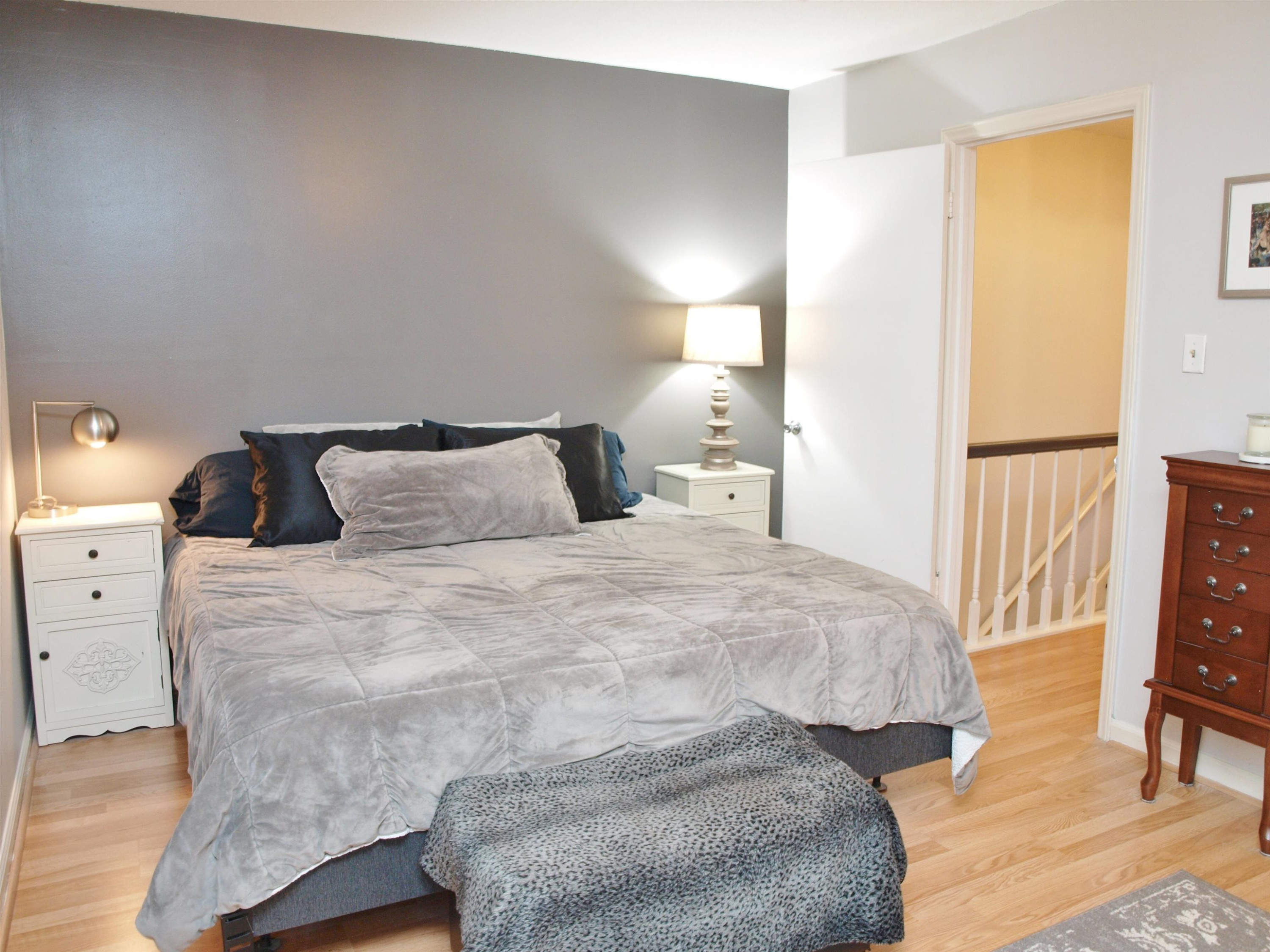 6313 New Market Way, Unit 6313 Raleigh, NC 27615 - Photo 14 of 18 a bedroom with a bed and wooden floor