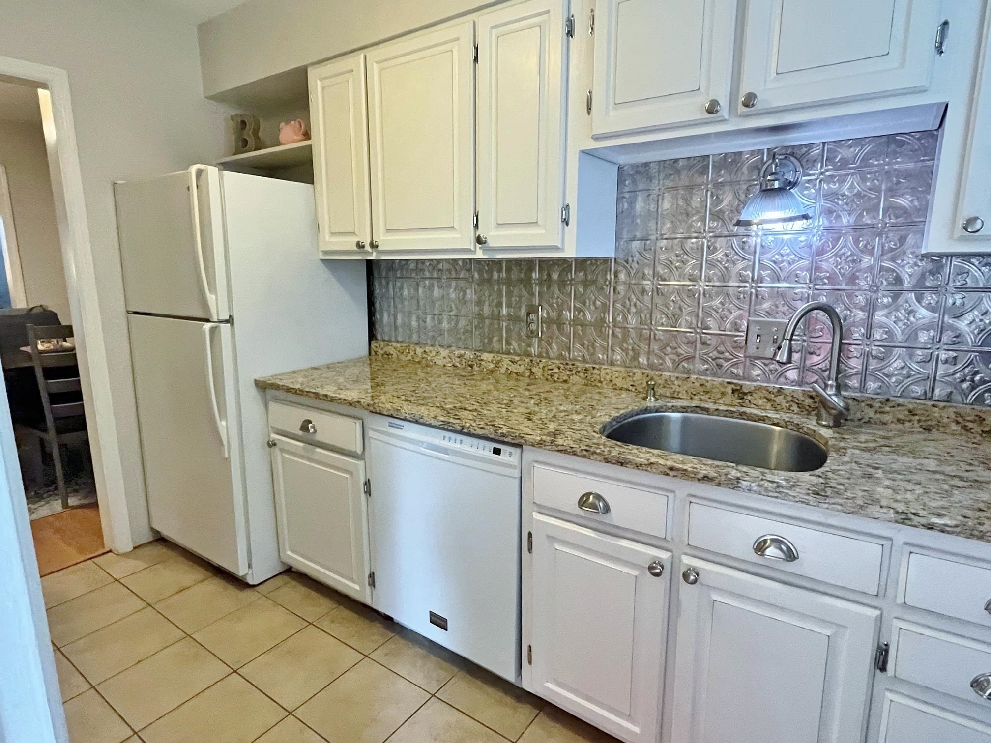6313 New Market Way, Unit 6313 Raleigh, NC 27615 - Photo 10 of 18 a kitchen with stainless steel appliances granite countertop a sink refrigerator and cabinets