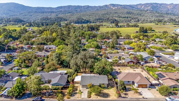 an aerial view of residential houses and lake