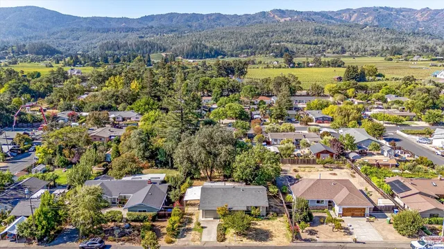 an aerial view of residential houses and lake