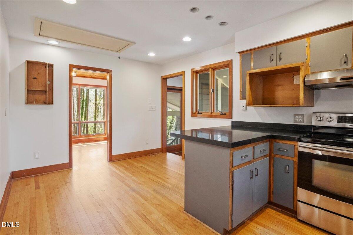 4805 Rembert Drive Raleigh, NC 27612 - Photo 10 of 45 a kitchen with stainless steel appliances granite countertop a stove and a sink