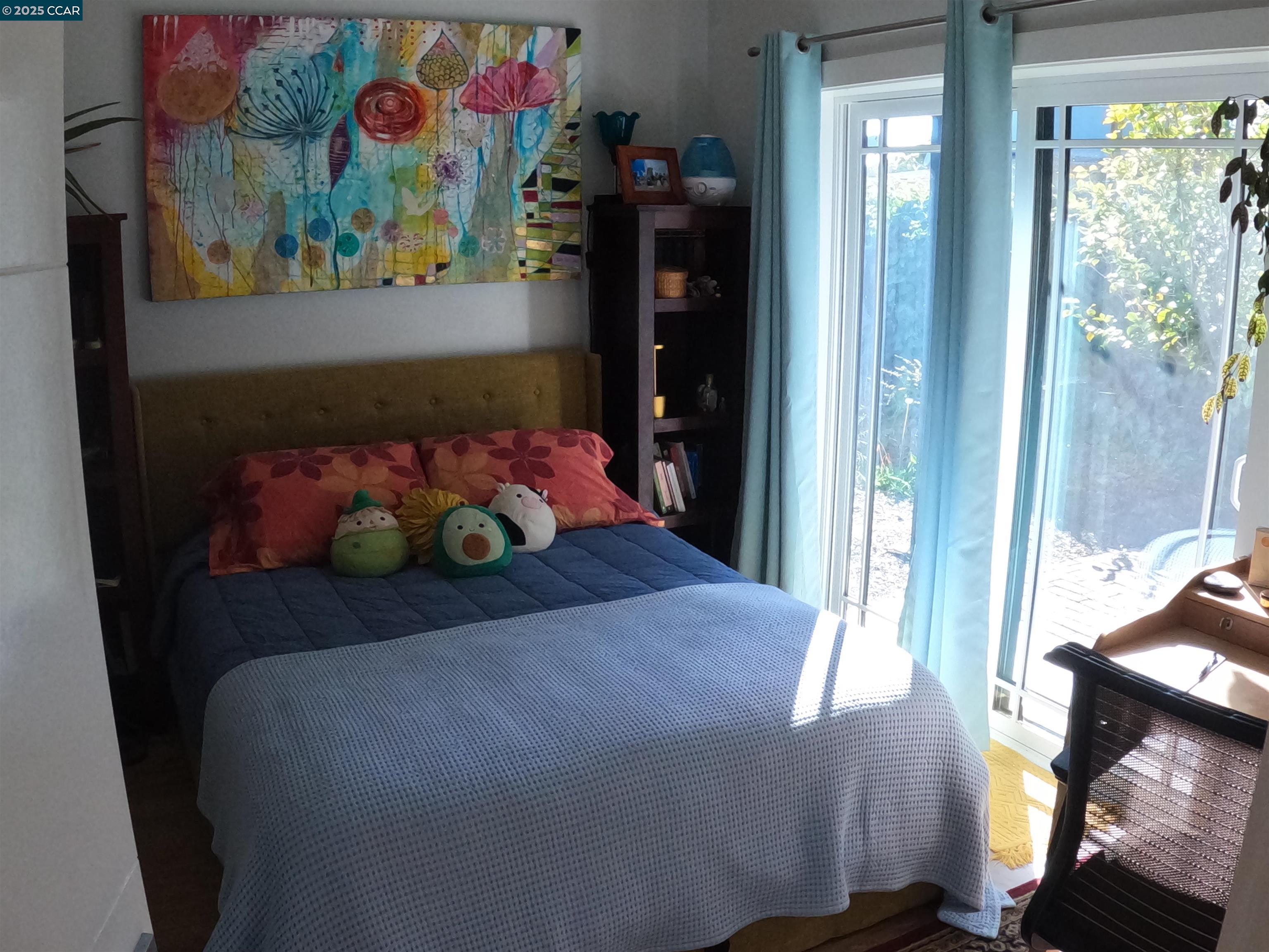1329 Hopkins Street, Unit D Berkeley, CA 94702 - Photo 11 of 16 a bedroom with a bed painting on wall and a window