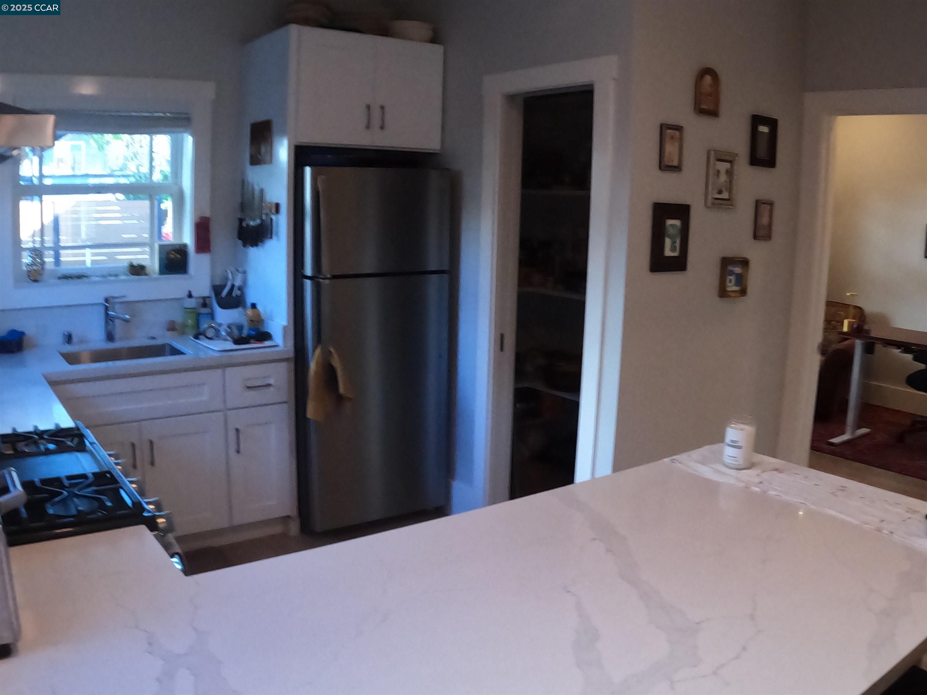 1329 Hopkins Street, Unit D Berkeley, CA 94702 - Photo 4 of 16 a kitchen with a refrigerator and a sink