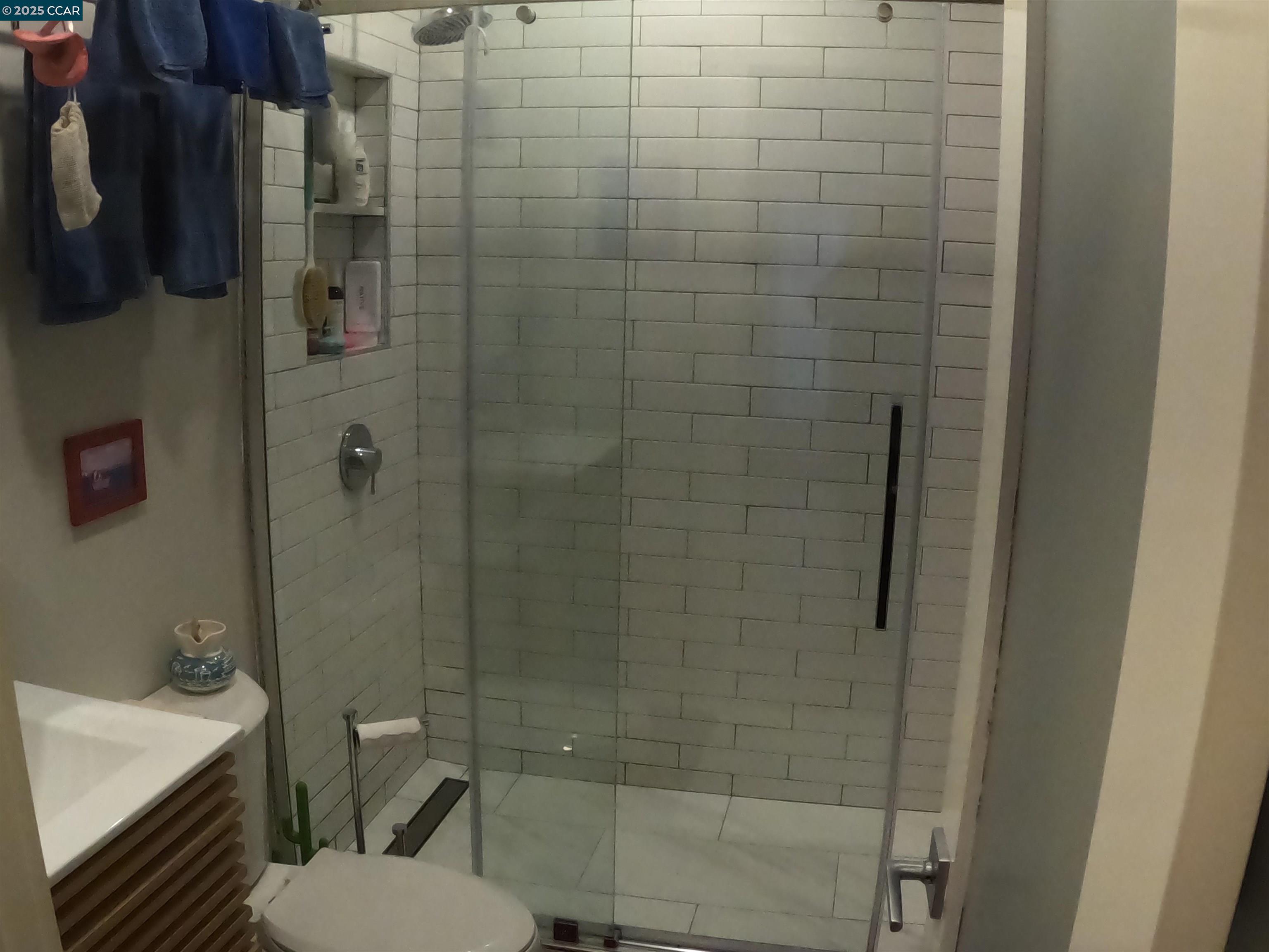 1329 Hopkins Street, Unit D Berkeley, CA 94702 - Photo 9 of 16 a bathroom with a toilet and a shower