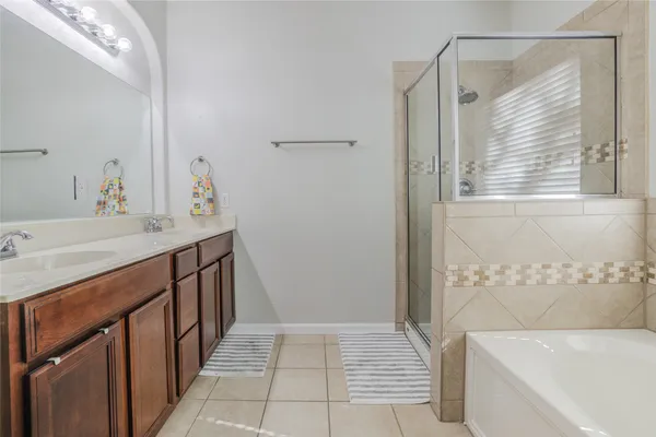 a bathroom with a tub sink and a mirror