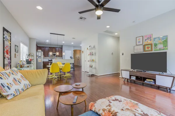 a living room with furniture and wooden floor