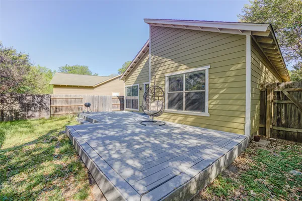 a view of a backyard with wooden fence