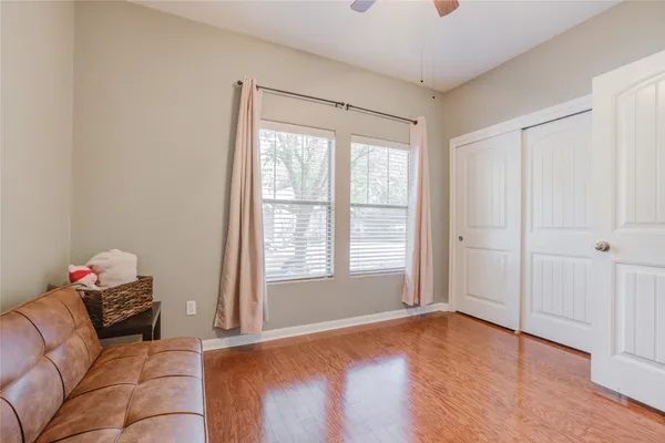 a bedroom with a bed and wooden floor