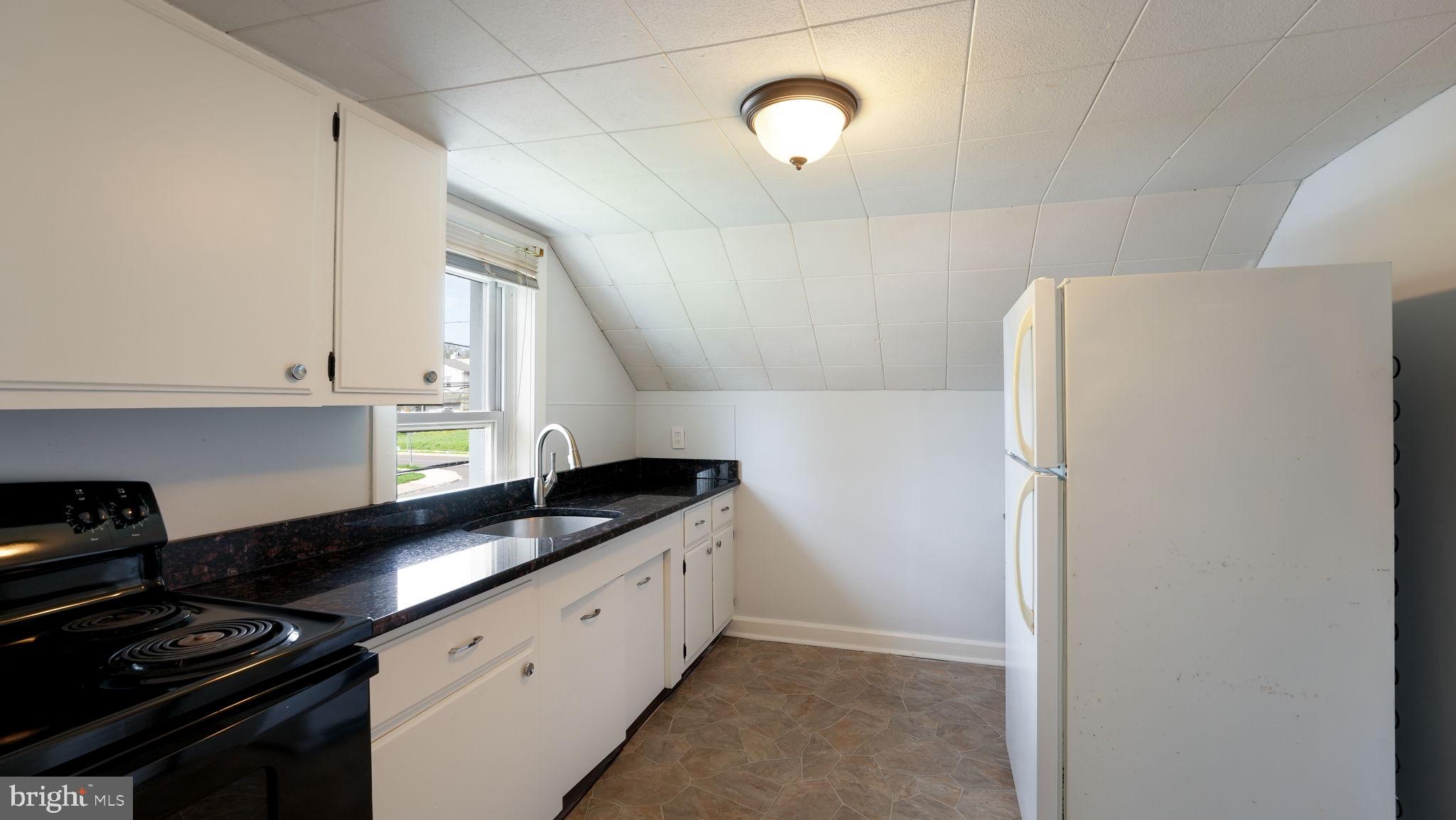 165 West Street Souderton, PA 18964 - Photo 26 of 31 a kitchen with granite countertop cabinets and refrigerator