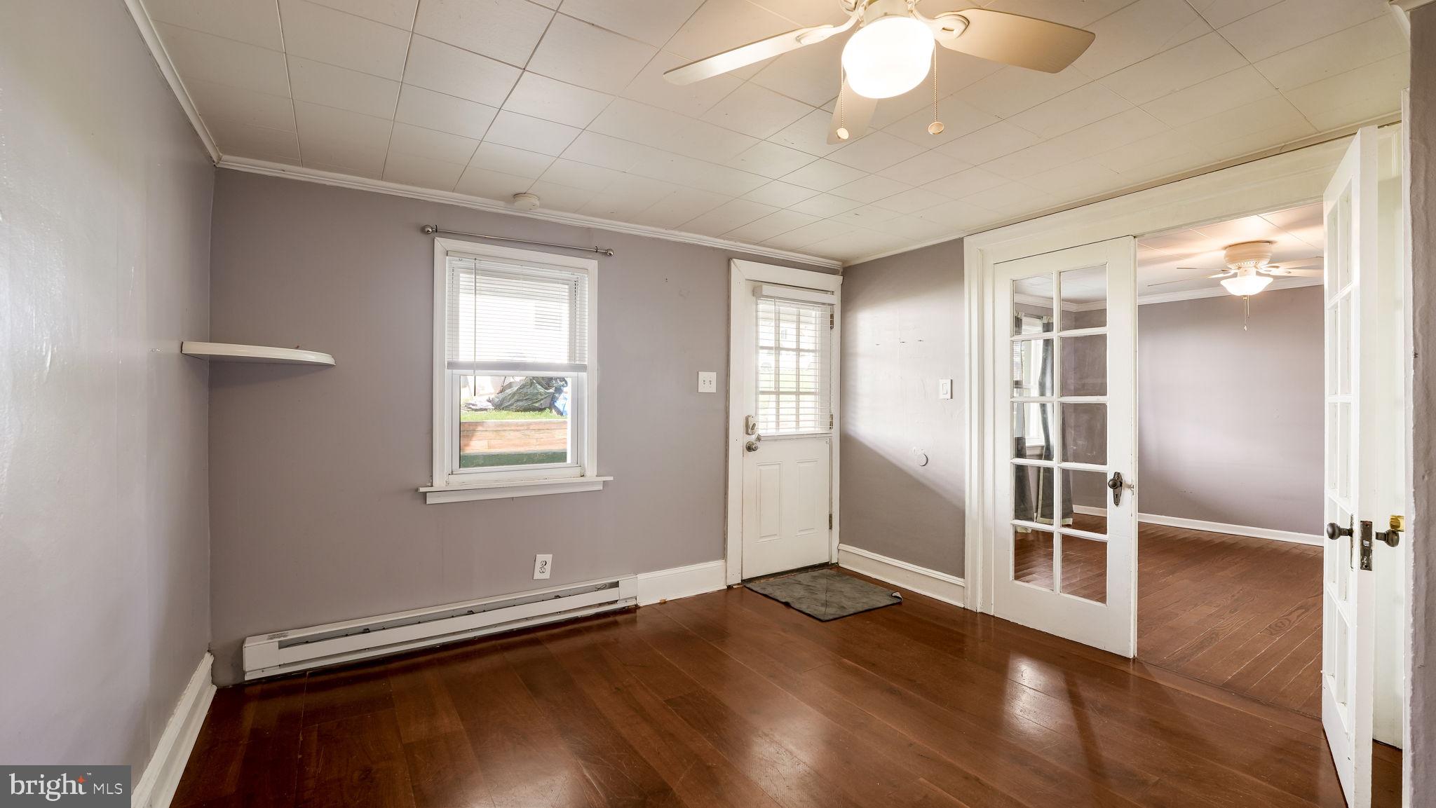 165 West Street Souderton, PA 18964 - Photo 4 of 31 an empty room with wooden floor cabinet and windows