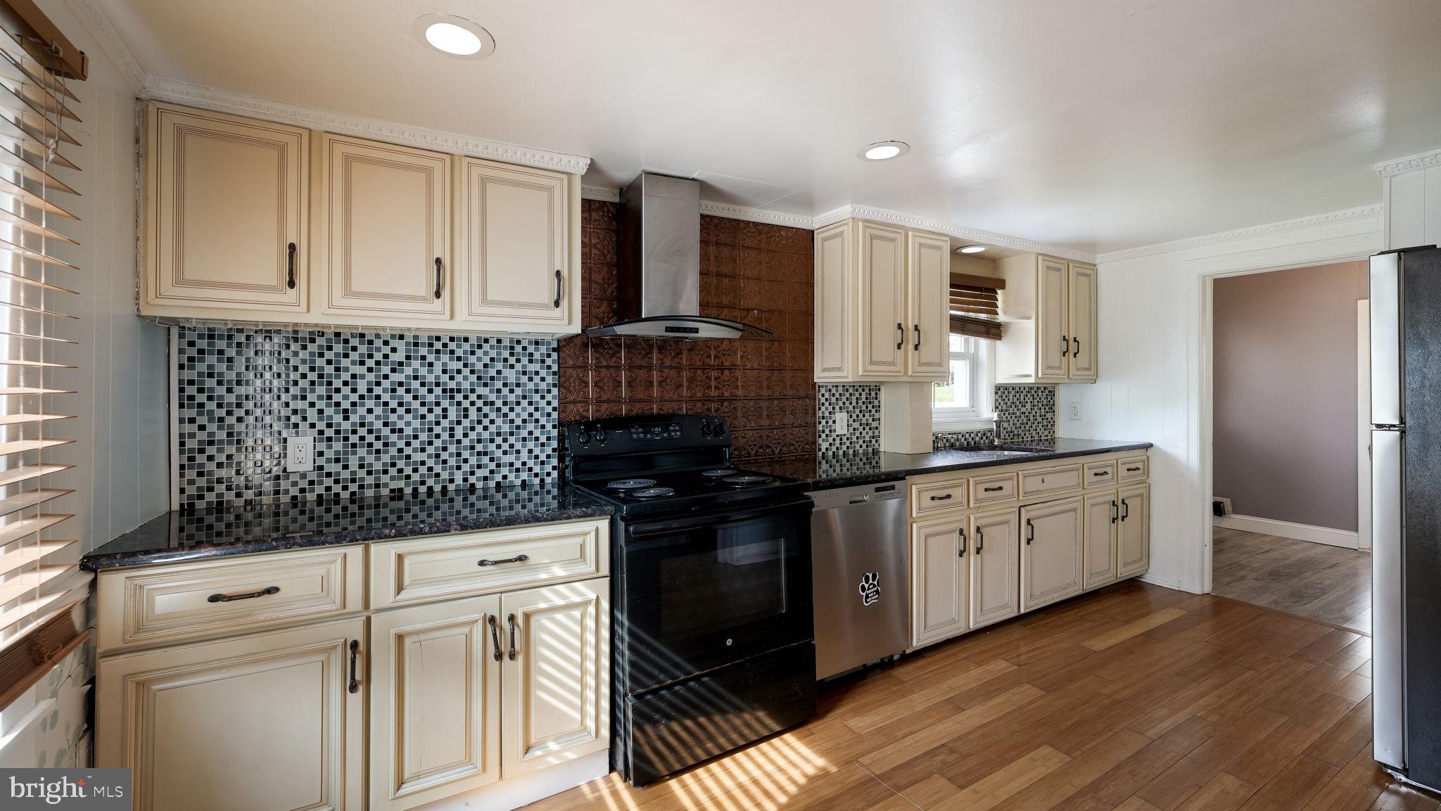 165 West Street Souderton, PA 18964 - Photo 10 of 31 a kitchen with granite countertop white cabinets and black appliances
