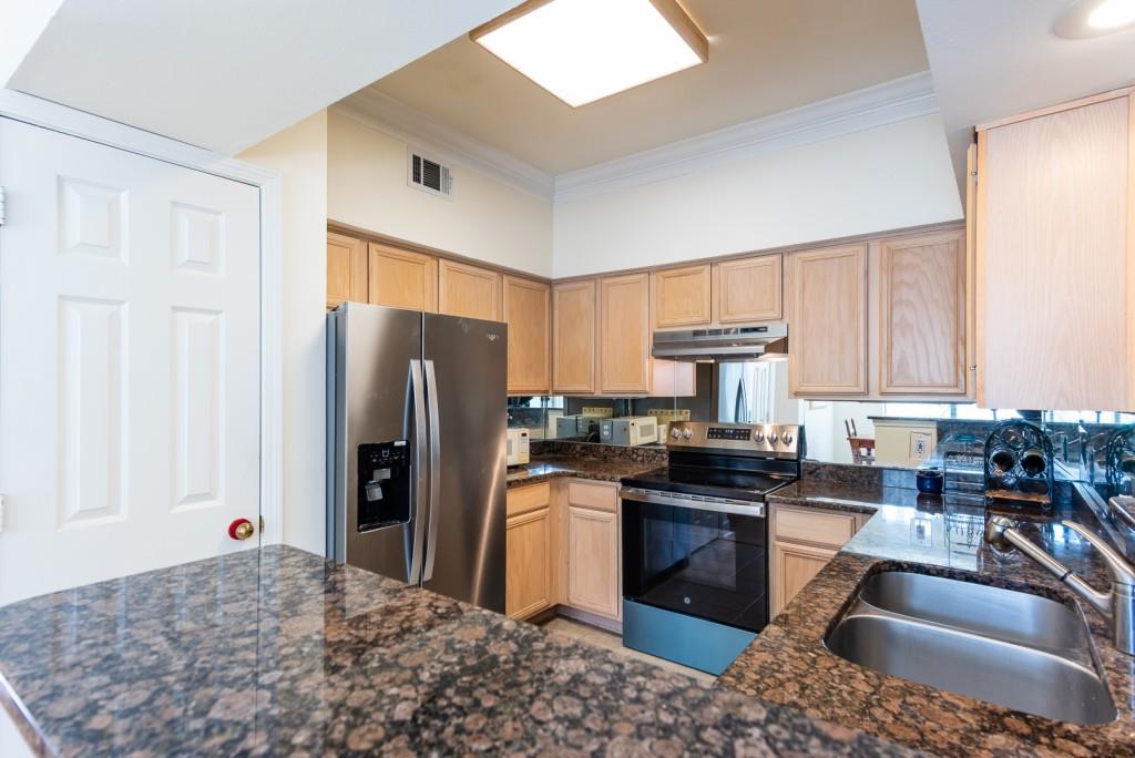 3777 Peachtree Road Northeast, Unit 1007 Brookhaven, GA 30319 - Photo 11 of 39 a kitchen with stainless steel appliances granite countertop a refrigerator stove and sink