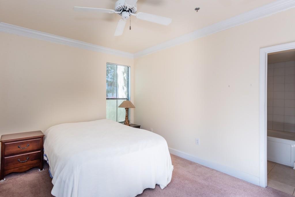 3777 Peachtree Road Northeast, Unit 1007 Brookhaven, GA 30319 - Photo 16 of 39 a bedroom with a bed and a chandelier